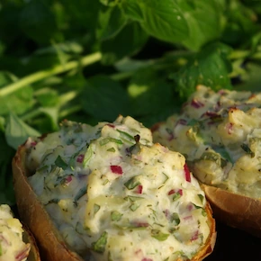 Stuffed potato skins used as a pizza base topped with veggies and sour cream